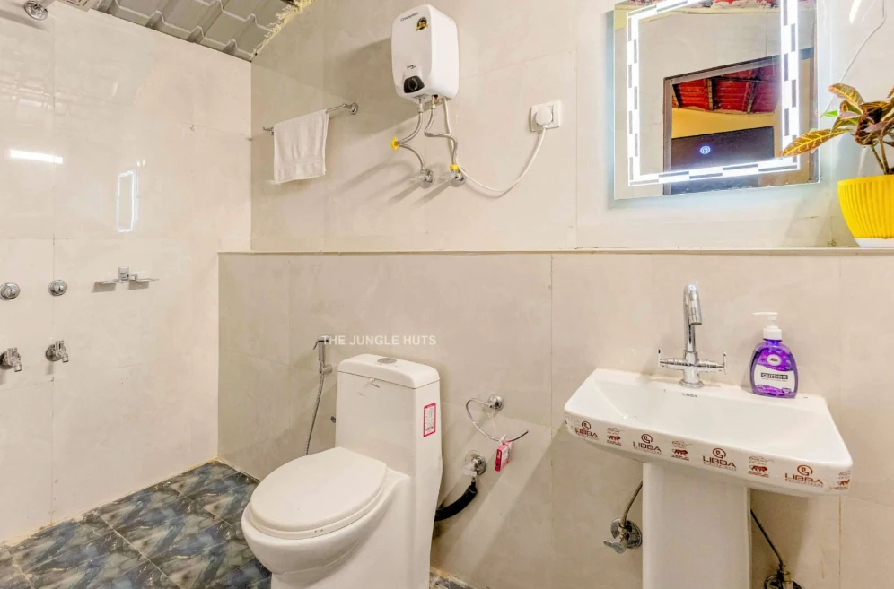 Light tiled bathroom with shower and washbasin