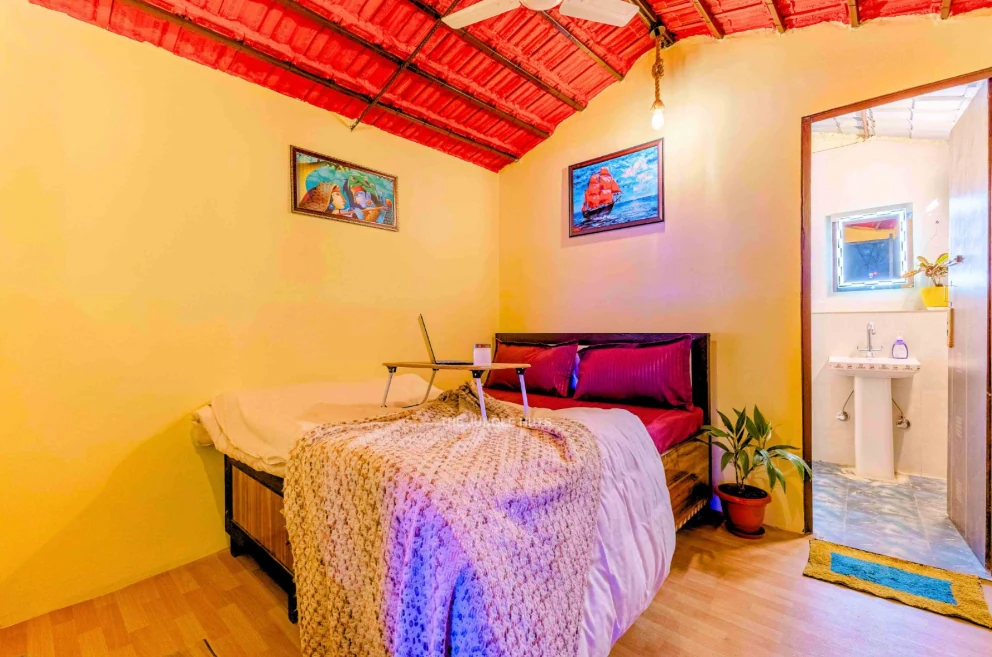 Bedroom with red ceiling and adjoining bathroom