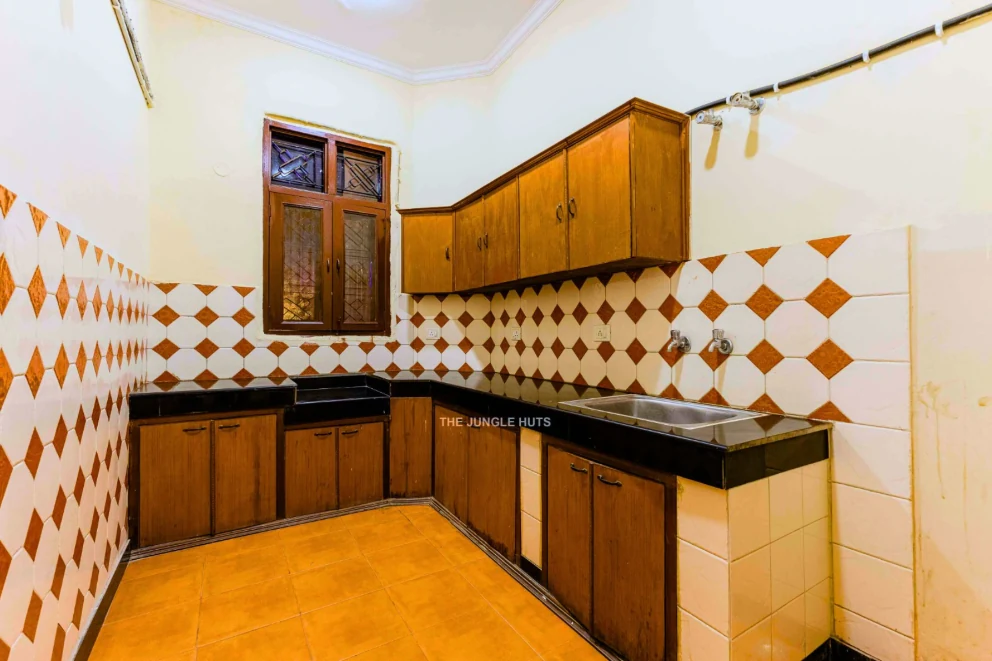 Kitchen area with wooden cabinets and sink